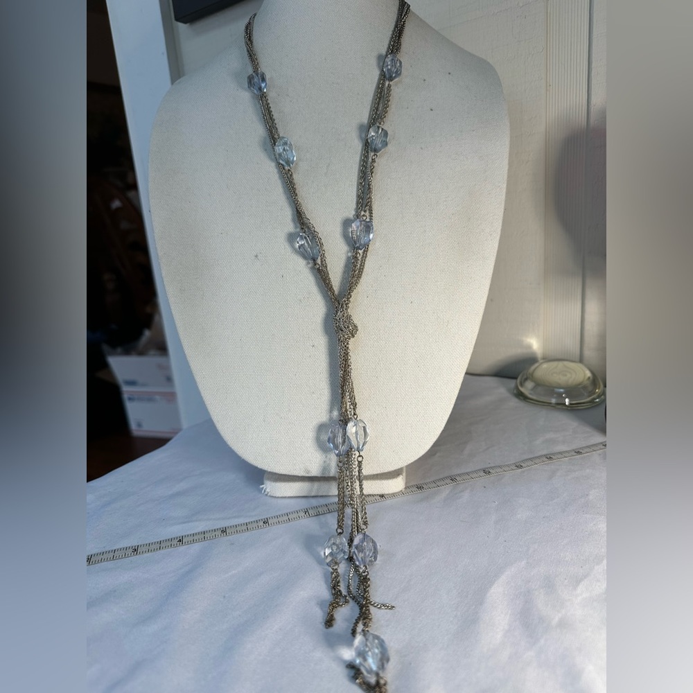 Long silvertone neck with larger ice blue beads